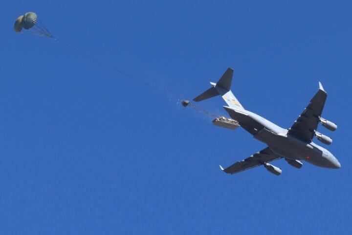 An M1093A2 Family of Medium Tactical Vehicle deploys out of a U.S. Air Force C-17 Aircraft at Fort Liberty, North Carolina during Low Velocity Airdrop testing. (Mr. Chris O’Leary, Airborne Special Operations Test Directorate, U.S. Army Operational Test Command)