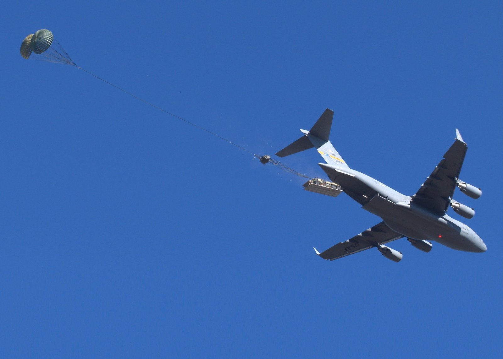 An M1093A2 Family of Medium Tactical Vehicle deploys out of a U.S. Air Force C-17 Aircraft at Fort Liberty, North Carolina during Low Velocity Airdrop testing. (Mr. Chris O’Leary, Airborne Special Operations Test Directorate, U.S. Army Operational Test Command)